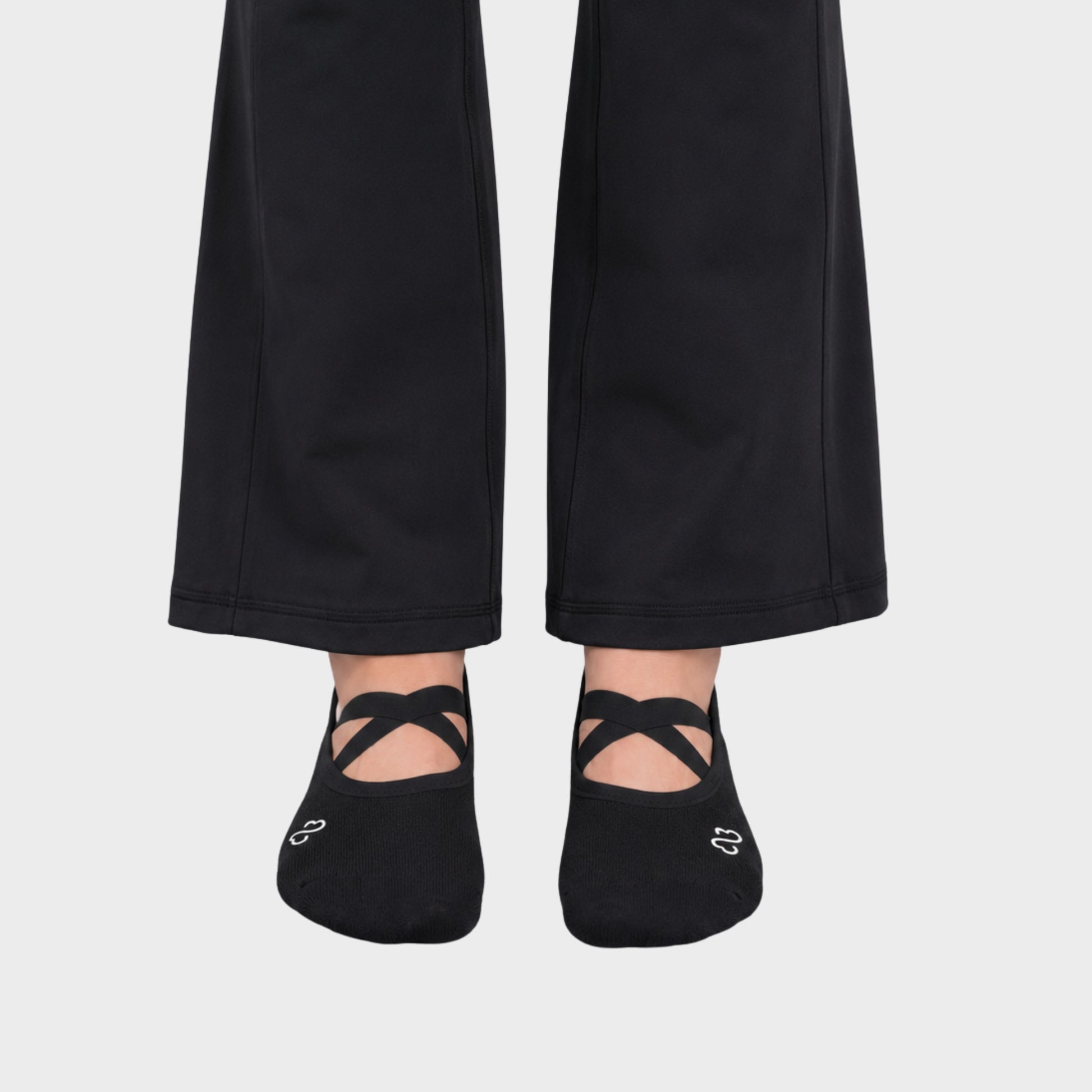 Bodiwealth Black cross strap yoga socks, front on model