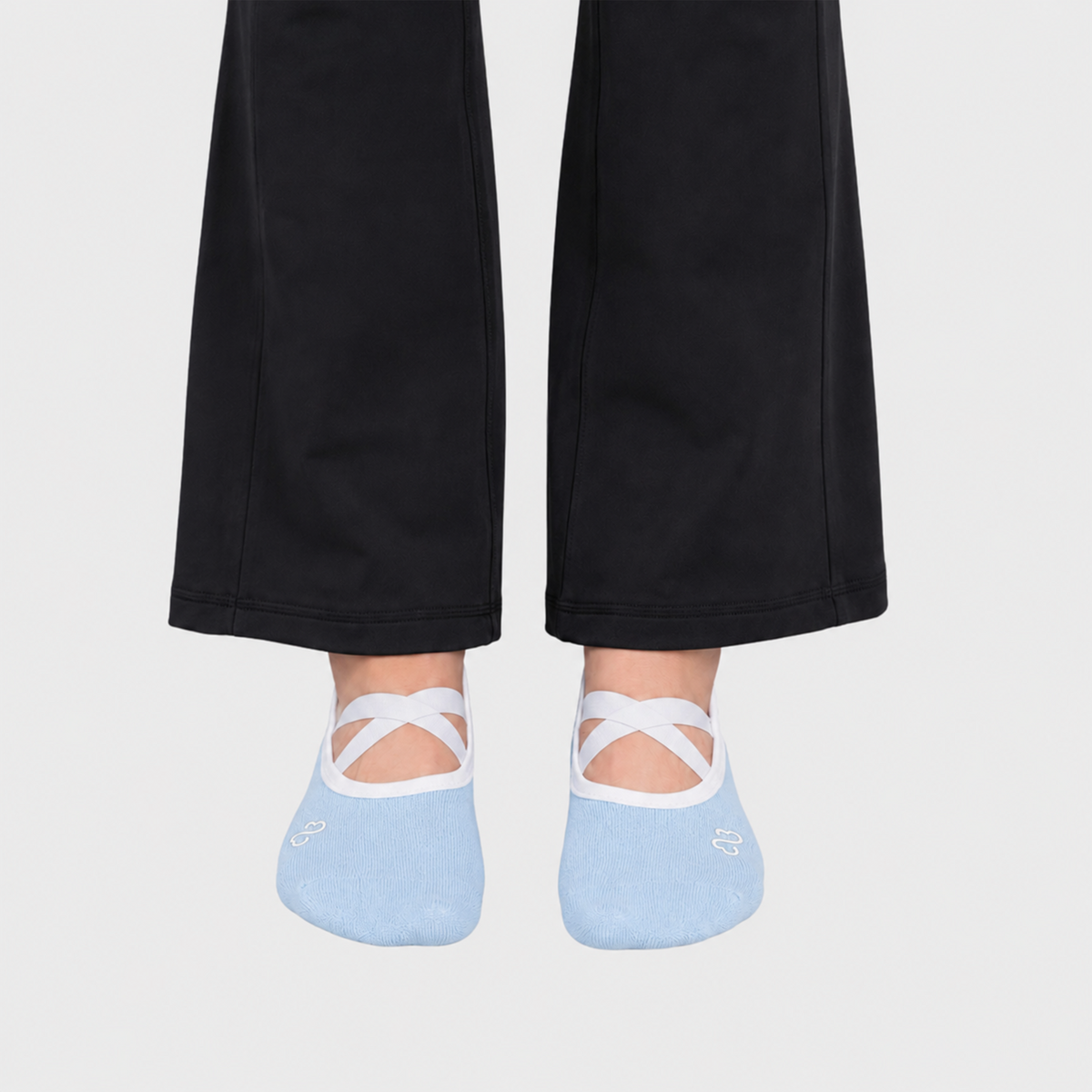 Bodiwealth blue cross strap yoga socks, front on model