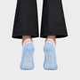 Bodiwealth blue cross strap yoga socks, back and grip on model