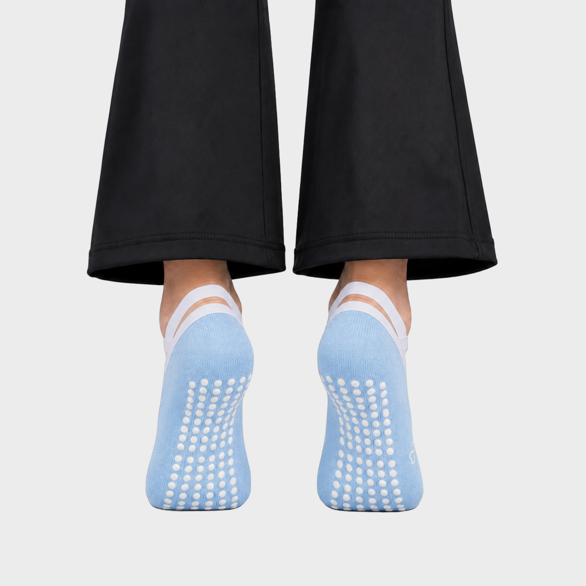 Bodiwealth blue cross strap yoga socks, back and grip on model